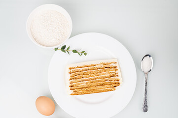 Handmade cake, baking ingredients on white background, top view