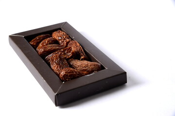 Fresh almonds in the wooden bowl, Organic almonds, almonds border white background, Almond nuts on a dark wooden background. Healthy snacks. Top view. Free space for text.