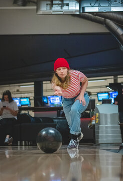 Professional female bowler throws his throw and is in position to watch his ball. Bowling life. An active sports afternoon. A young blond boy is bowling. Competition. Sotkamo, Finland