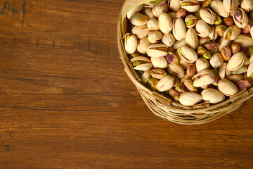 Fresh almonds in the wooden bowl, Organic almonds, almonds border white background, Almond nuts on a dark wooden background. Healthy snacks. Top view. Free space for text.