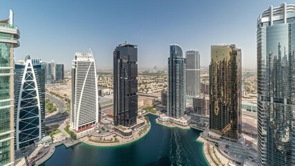 Fototapeta na wymiar Panorama showing tall residential buildings at JLT aerial timelapse, part of the Dubai multi commodities centre mixed-use district.