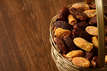 Fresh almonds in the wooden bowl, Organic almonds, almonds border white background, Almond nuts on a dark wooden background. Healthy snacks. Top view. Free space for text.