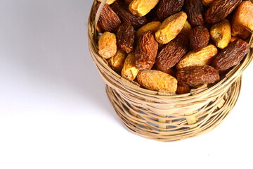 Fresh almonds in the wooden bowl, Organic almonds, almonds border white background, Almond nuts on a dark wooden background. Healthy snacks. Top view. Free space for text.