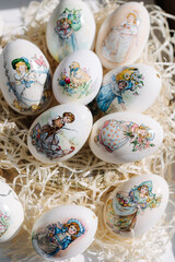 Lots of different drawings on goose eggs for Easter festival. Eggs on hay. Hand made print. Spring hollidays. Easter concept