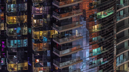 Night view of glowing windows in apartment tower timelapse.