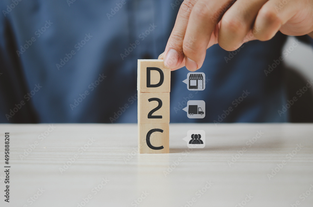 Poster hand put wooden cubes with direct to consumer d2c and icon on table and copy space.business concepts