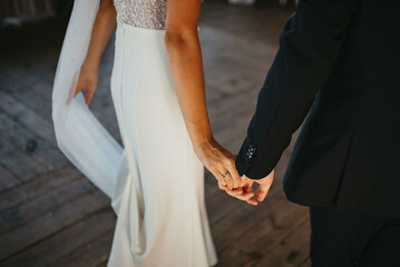 Happy couple in love, bride and groom cuddle and look at each other. This day is the first of many beautiful days together.