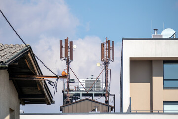 Fototapeta na wymiar Mobile phone and internet cell tower over against sky. 5G wireless radiation antennas.