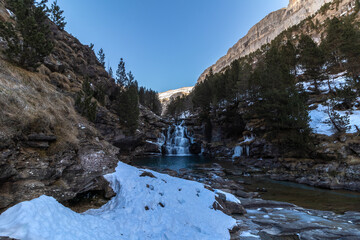 waterfall in ordesa national park in the spanish pyrenees in winter