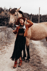 Bohemian, boho, gypsy, hippie style lady. Walk in nature in the forest with a horse, romantic mood of summer