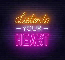 Fototapeta na wymiar Listen to your heart neon lettering on brick wall background.