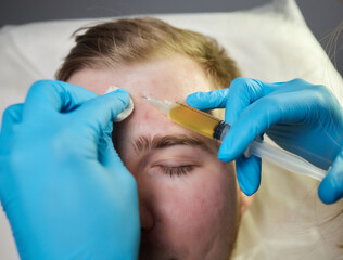 Injection at spa salon. Doctor hands in gloves. Closeup. Pretty male patient. Beauty treatment....