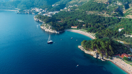 Aerial top down view of boat dock and yacht port in Montenegro. White private motor boats are moored to pier on Adriatic sea coast. Yacht club boats parking. Photo from drone.