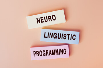 Neuro Linguistic Programming. Concept of text on color cards. Top view image of cards and on pastel...