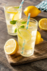 Glass of fresh lemonade on wooden table