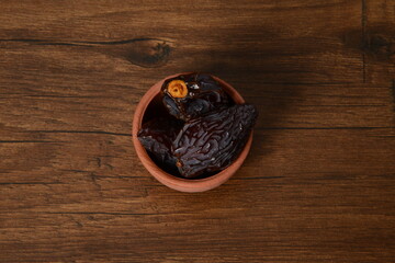 Fresh almonds in the wooden bowl, Organic almonds, almonds border white background, Almond nuts on a dark wooden background. Healthy snacks. Top view. Free space for text.