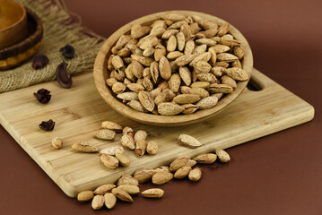 Almonds in wooden bowl spread 