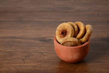 Fresh almonds in the wooden bowl, Organic almonds, almonds border white background, Almond nuts on a dark wooden background. Healthy snacks. Top view. Free space for text.