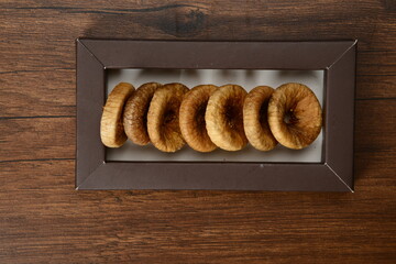 Fresh almonds in the wooden bowl, Organic almonds, almonds border white background, Almond nuts on a dark wooden background. Healthy snacks. Top view. Free space for text.