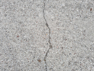 Crack on a grey concrete floor, wall, surface, grey texture