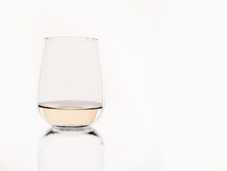 white wine or apple juice in a transparent glass isolated over white background