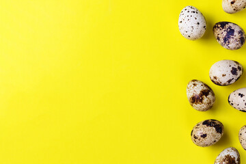 Easter greeting card with quail eggs on a yellow background