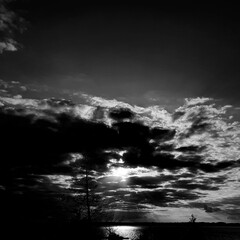 the sun behind the clouds