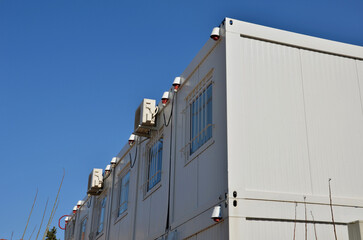 modular housing in stacked container cells. each module has a different function. part is a stair...