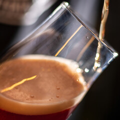 bartender pour beer in to the shiny glass square