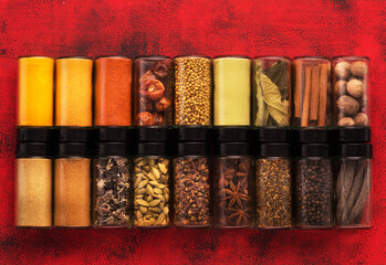 Spices, herbs, spicy and seasoning in glass jars top view. Spices background