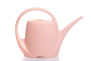 plastic Garden watering can of pink color with a handle on a white isolated background