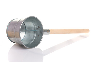 stainless steel metal ladle with a wooden handle for a bath or sauna on a white isolated background