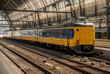 Fototapeta na wymiar Amsterdam, Netherlands, march 2022. Dutch train in the landscape and in the central station