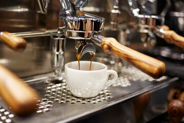 espresso machine pouring coffee into a cup