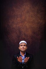 islamic background of muslim man praying to allah with rosary on hands