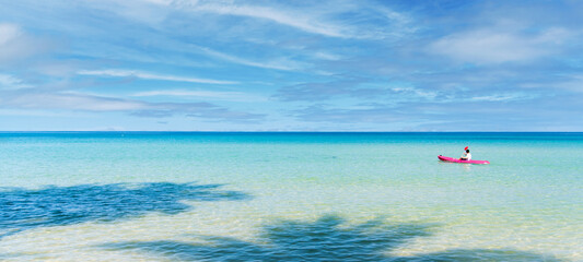 Man paddling the kayak at beautiful sea beach tropical in summer