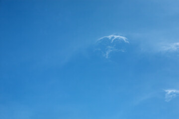 Light fluffy clouds against a clear blue sky