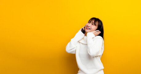 music listening to music Beautiful Asian woman in headphones listening to music and enjoying the sound of music. on a yellow background