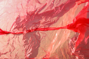 The texture of a crumpled pink package with selective focus, pink abstraction