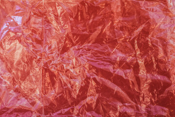 Texture of a red crumpled package, red background