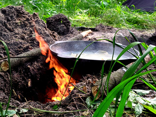 Сamping kitchen. Fish soup in nature. Fish soup in a cauldron in nature. Vacation with tents stock image