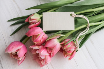 Bouquet of pink tulips and tag mockup for text on white background