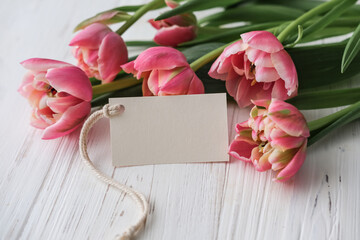 Bouquet of pink tulips and tag mockup for text on white background