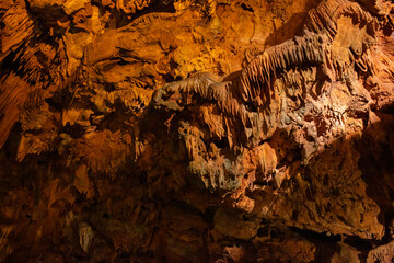 Beautiful view of stalactites and stalagmites in Damlatas underground cave, Alanya-Turkey. Cave dwellings and combinations of features. 