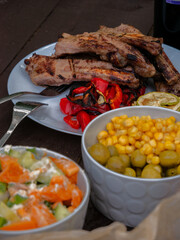 Assorted delicious grilled meat with vegetables over the coals on a barbecue