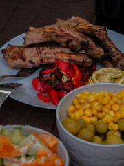 Assorted delicious grilled meat with vegetables over the coals on a barbecue