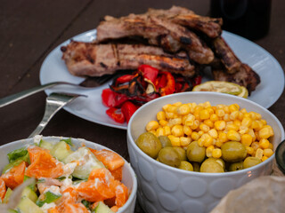 Assorted delicious grilled meat with vegetables over the coals on a barbecue