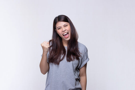 Image of feeling excited, shock, surprise and happy. Young asian woman standing on white background. Female face expressions and emotions body language concept.