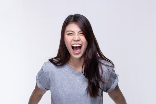 Image of feeling excited, shock, surprise and happy. Young asian woman standing on white background. Female face expressions and emotions body language concept.