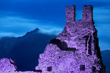 Spooky night at the Selva Castle. In the background Mount Cima Vezzena. Levico Terme, Trentino,...